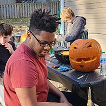 Dominique carving pumpkin