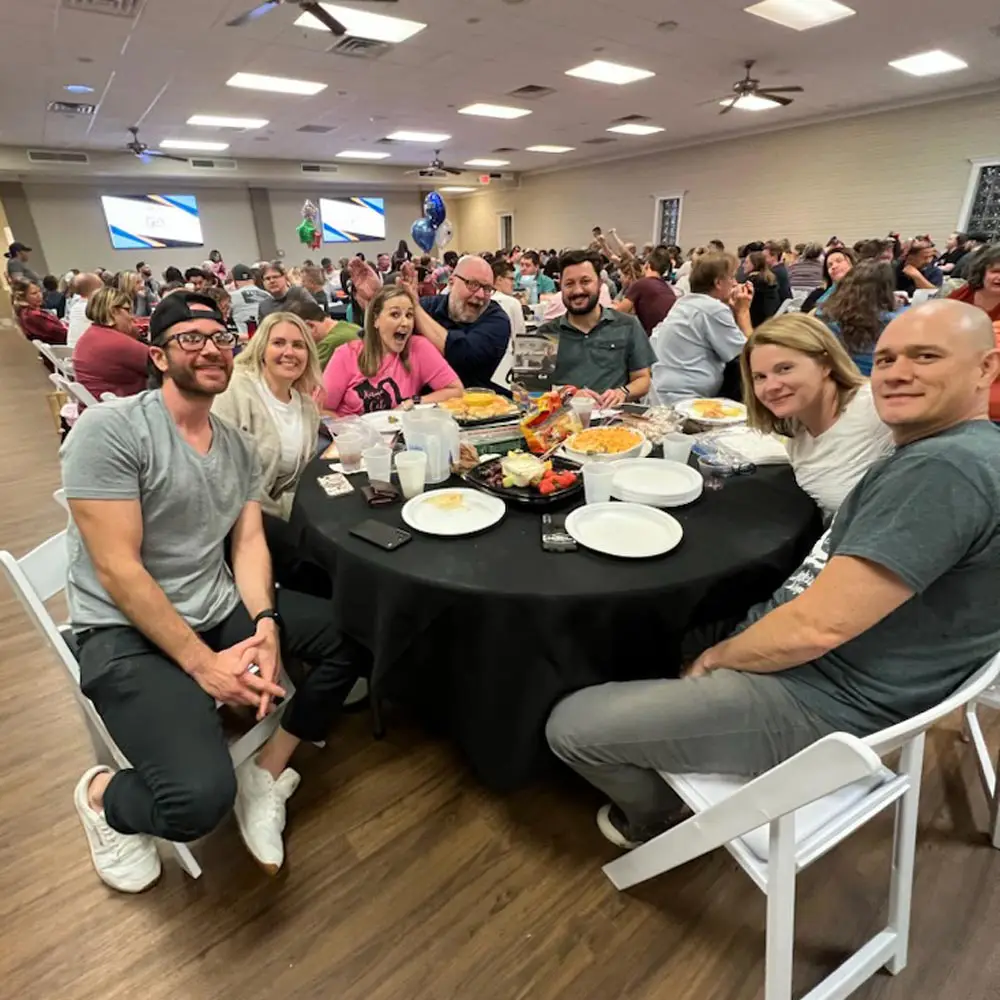 Members of the Thoughtprocess Interactive team at a table for trivia night.